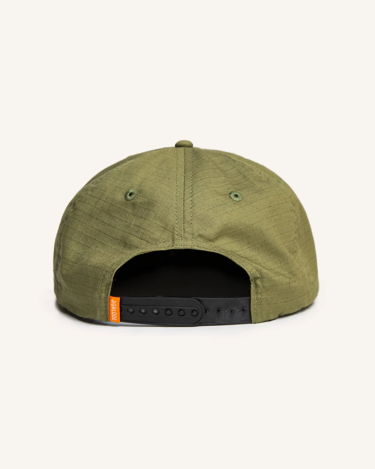 Back of the Seaworthy fishing Snapback. It is green with an orange patch with a yellow border. The patch features a poling skiff that says "Seaworthy Goods"
