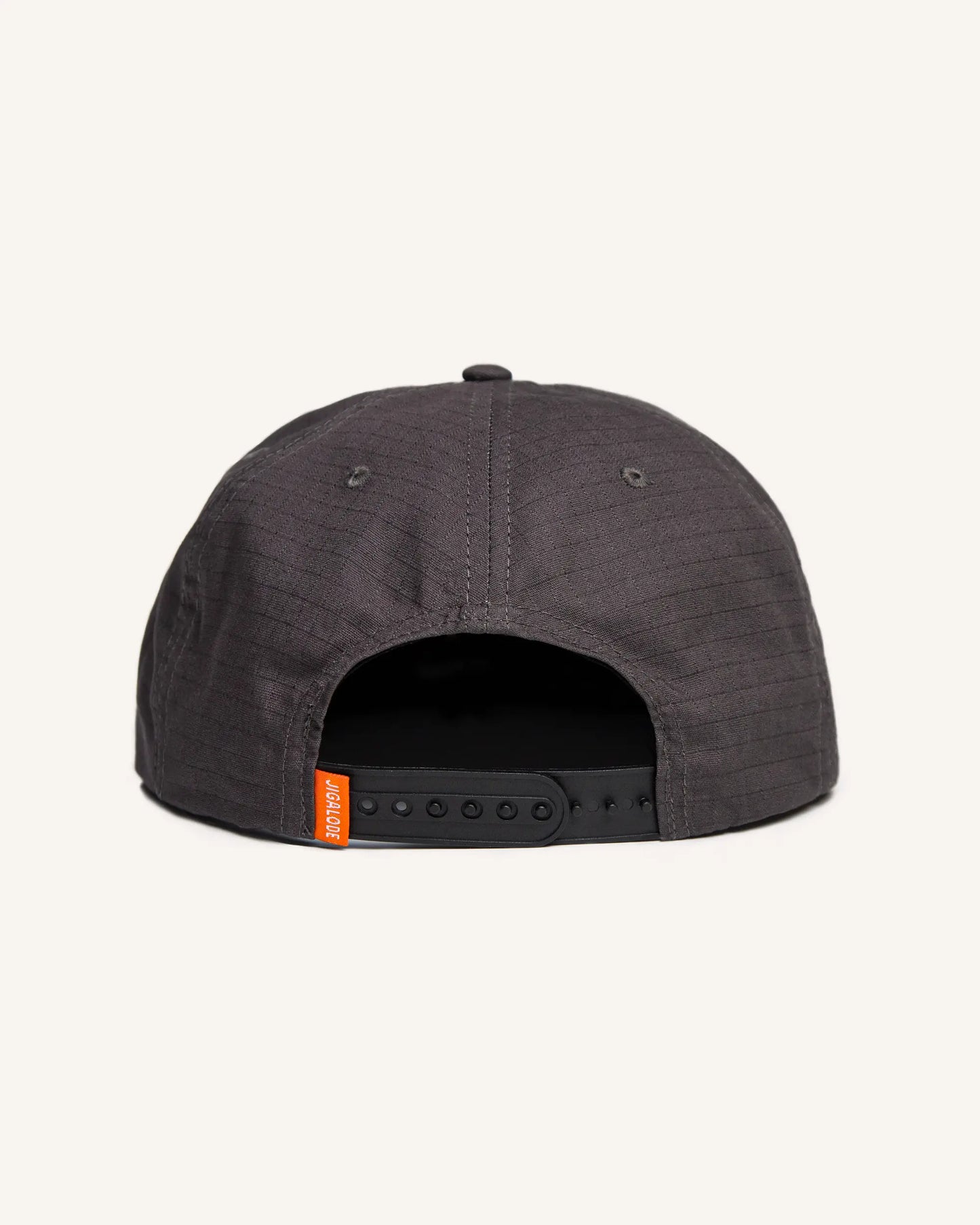 Charcoal gray fishing snapback with an orange and gray Jigalode patch that says "Gear for wild times"