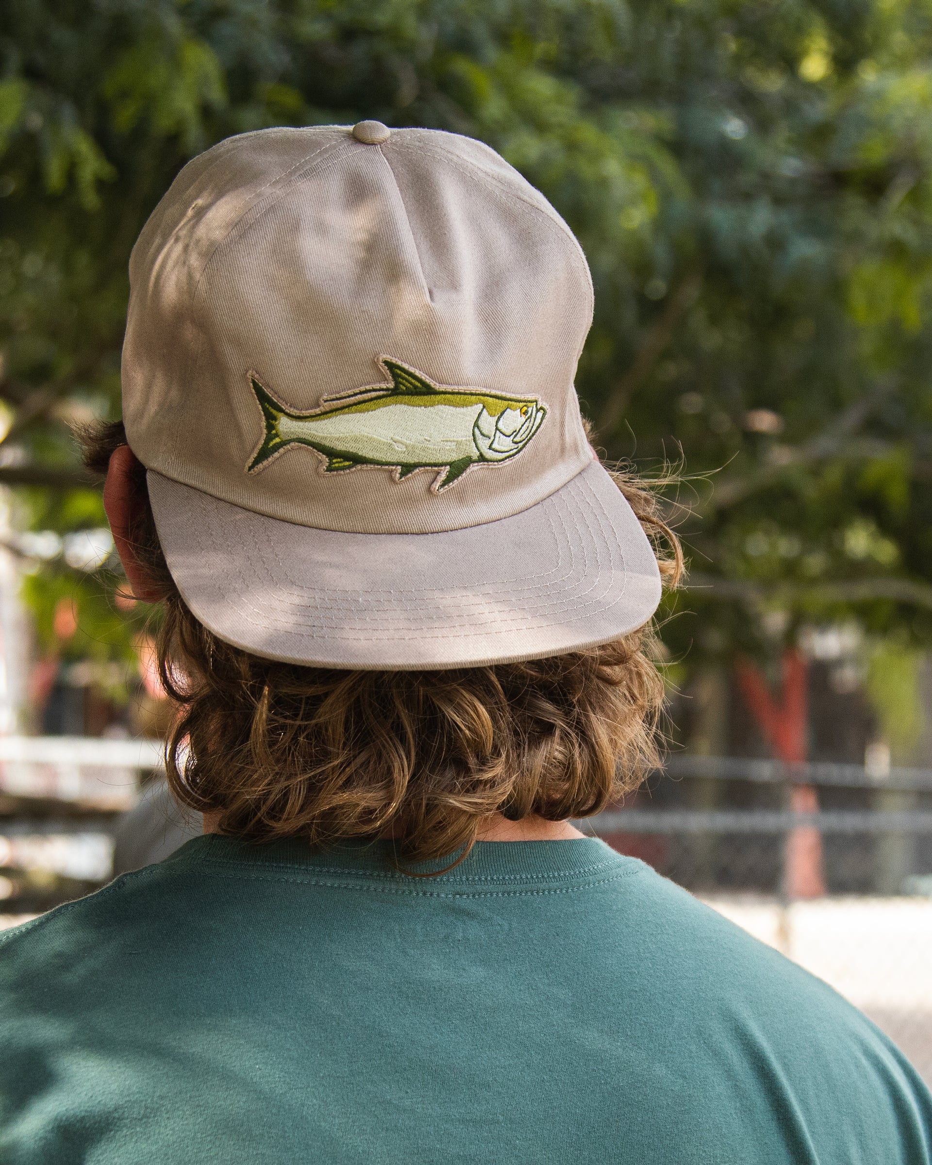Model wearing the Jigalode "Tarpon" fishing snapback. This unstructured 5-panel snapback features a large tarpon patch in the front.