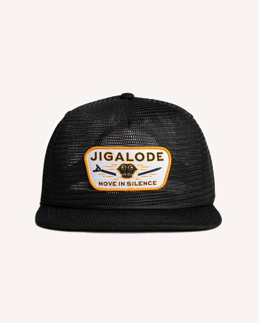 Front view of the 'Move In Silence' Mesh Snapback fishing hat in all black. The hat features a full mesh design for breathability and style. The paracord rope detail across the brim adds a distinctive touch. The golden yellow patch on the front displays an alligator snapping a push pole in half, making a powerful statement.