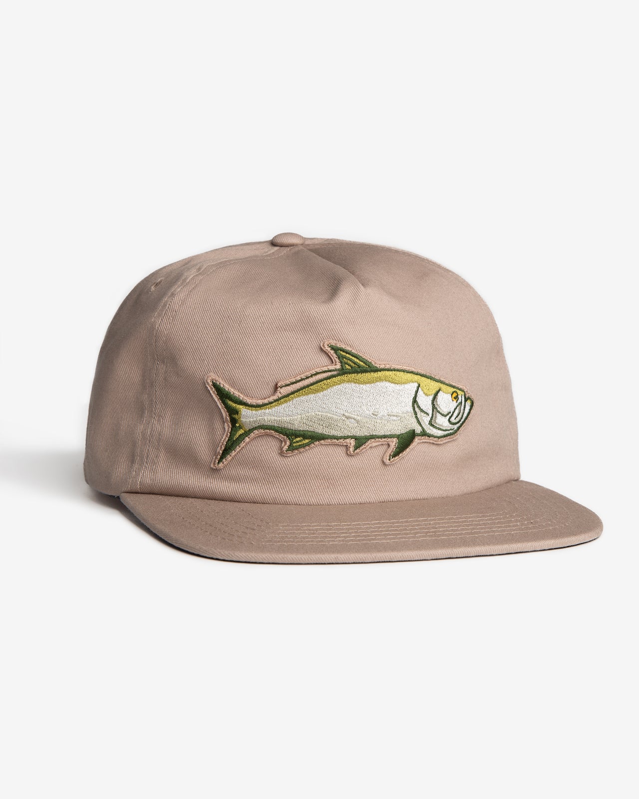 Angled front view of the Jigalode "Tarpon" Snapback fishing hat. The hat is a tan/khaki unstructured flat brim with a large tarpon patch in the front.