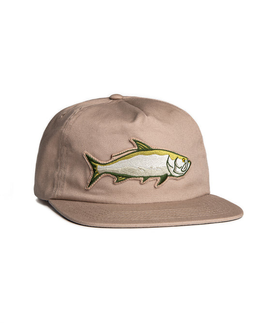 Angled front view of the Jigalode "Tarpon" Snapback fishing hat. The hat is a tan/khaki unstructured flat brim with a large tarpon patch in the front.