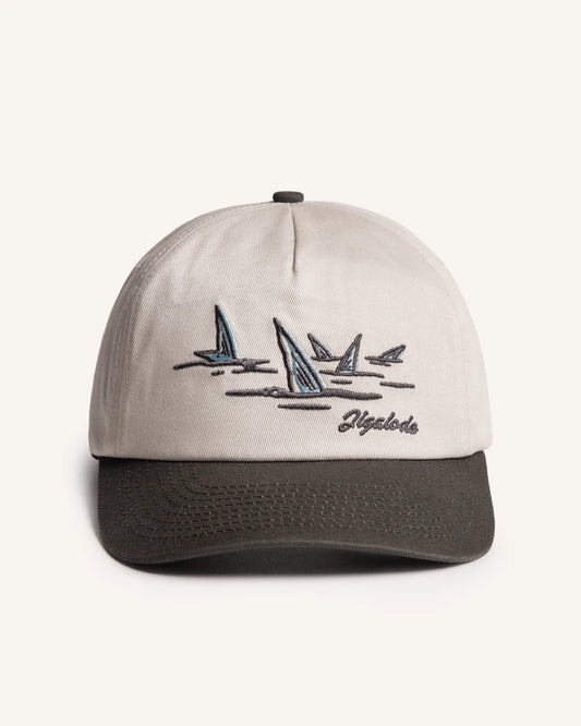 Front shot of the Tailer Snapback. It is a tone toned hat (Natural crown with a dark gray brim) retro styled snapback with a school of bonefish tails embroidered in the front.