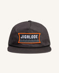 Charcoal gray fishing snapback with an orange and gray Jigalode patch that says "Gear for wild times"
