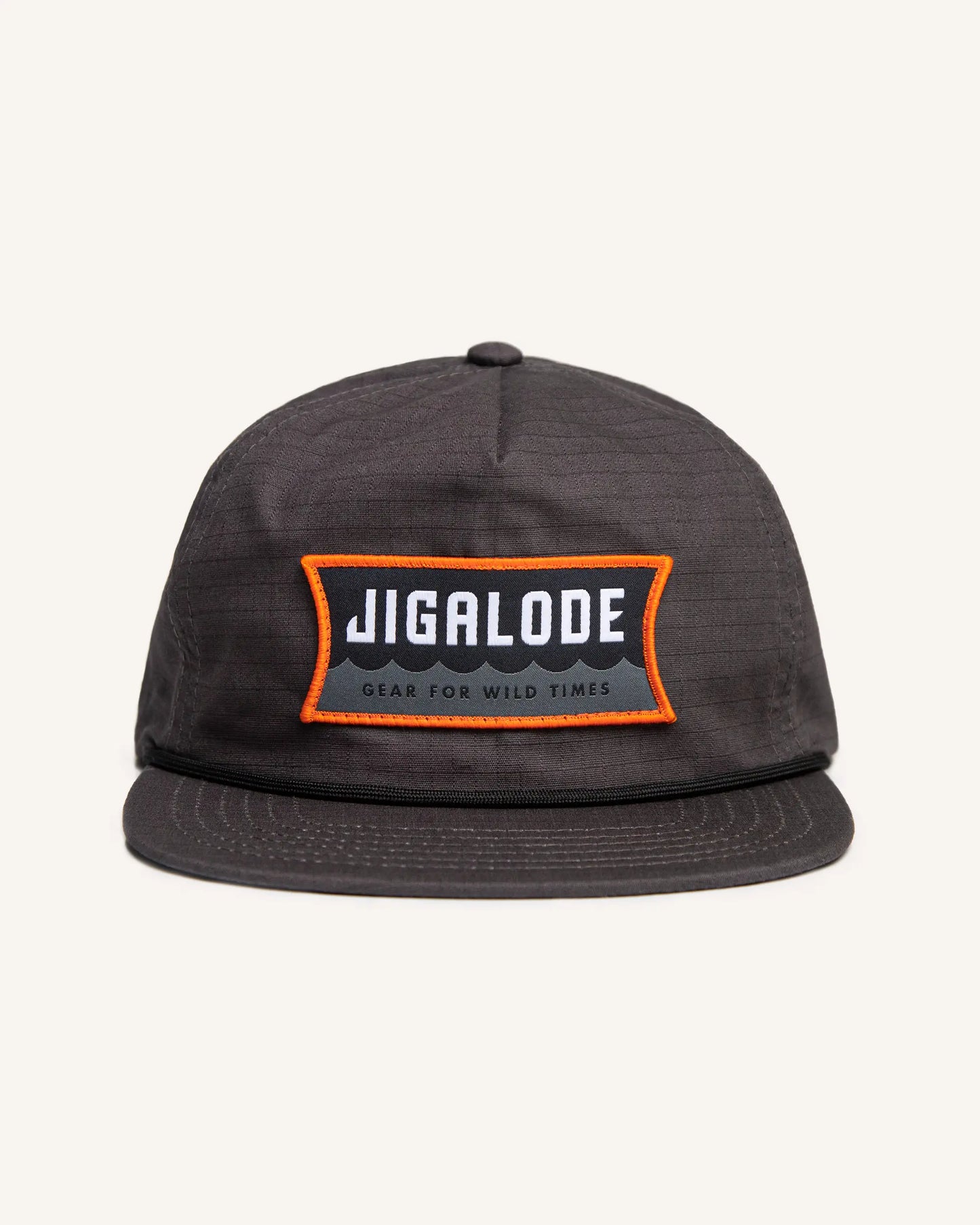 Charcoal gray fishing snapback with an orange and gray Jigalode patch that says "Gear for wild times"