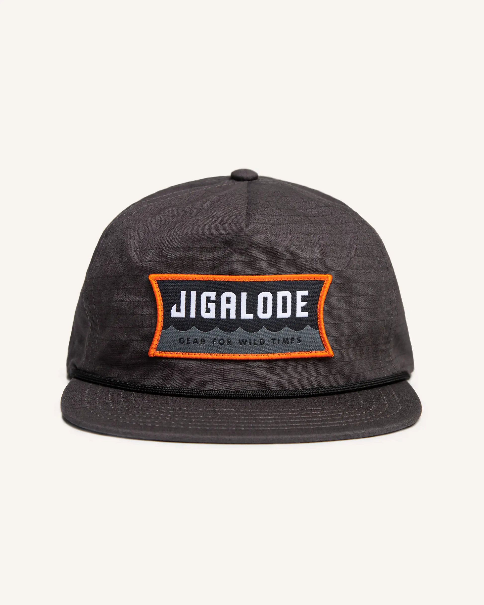 Charcoal gray fishing snapback with an orange and gray Jigalode patch that says "Gear for wild times"