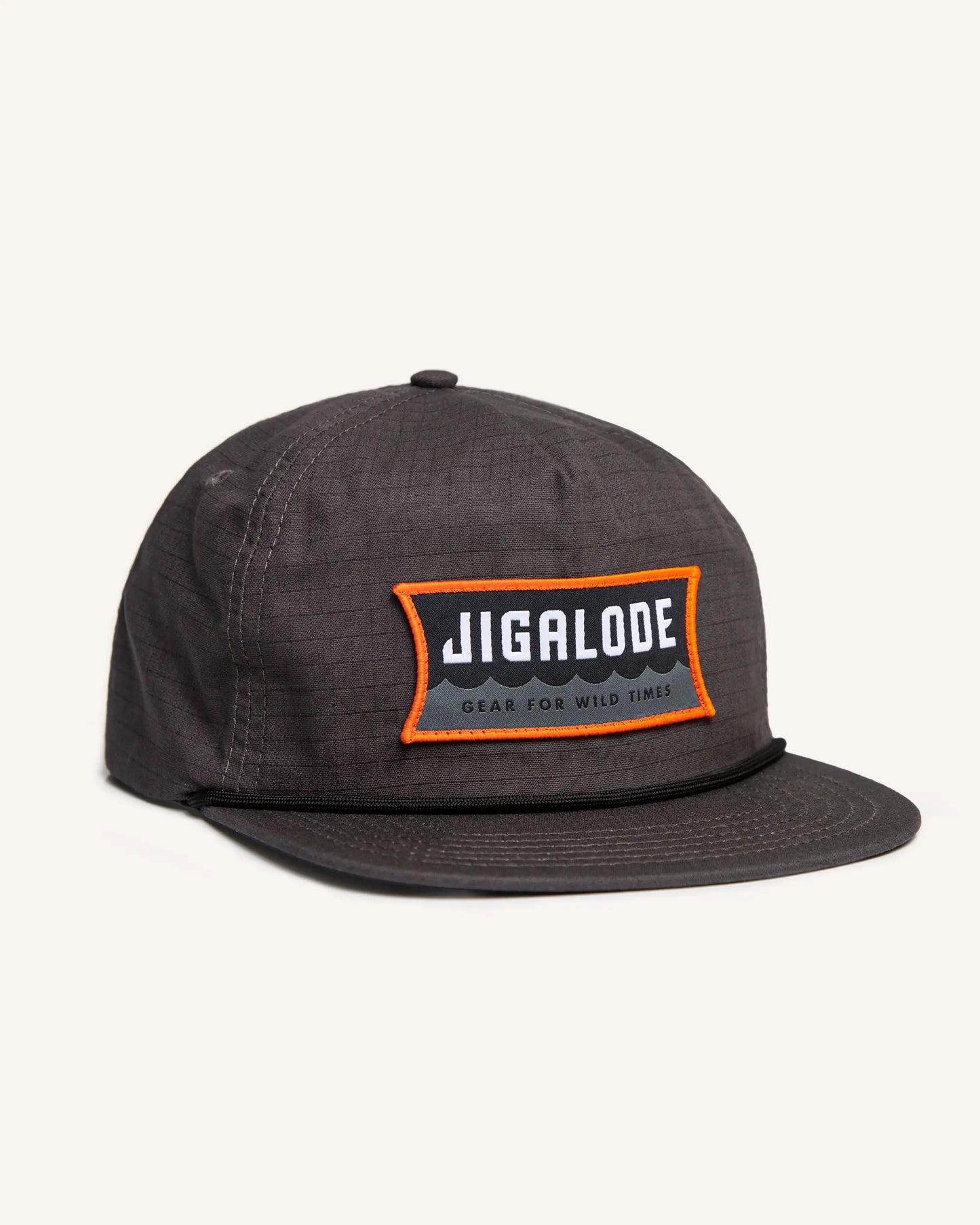 Charcoal gray fishing snapback with an orange and gray Jigalode patch that says "Gear for wild times"